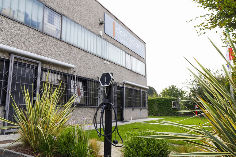 Dott. Solari headquarters exterior. EV charging station in front of the company building. Company profile image.
