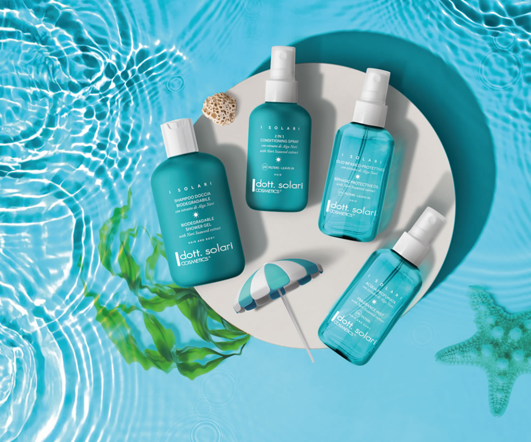 I Solari Cosmetics product line featuring shampoo, conditioner, and fragrance mist, displayed with a starfish and beach umbrella.