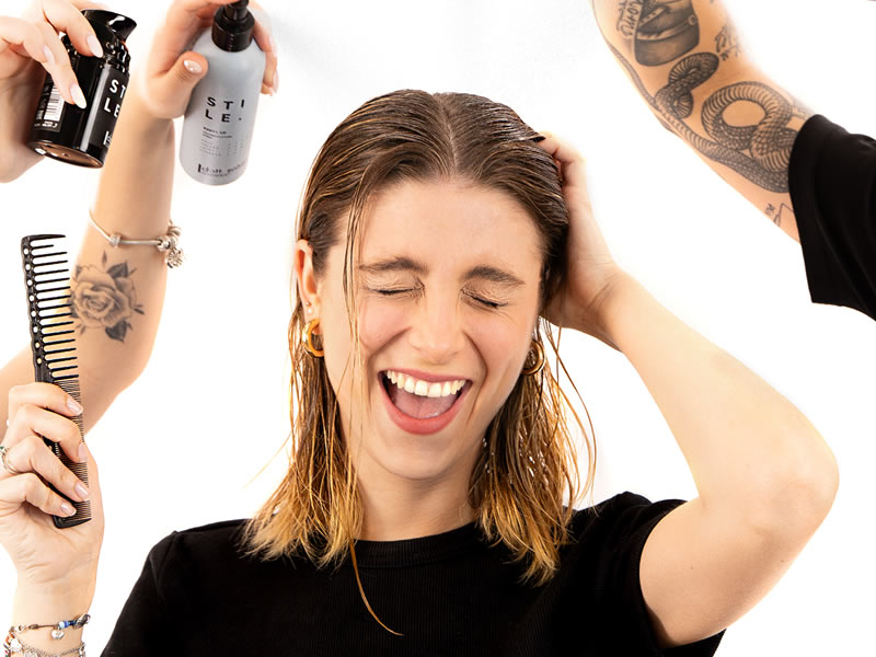 Perfect Hairdo Secrets: Woman with wet hair, surrounded by hair products like spray, comb, and styling product.