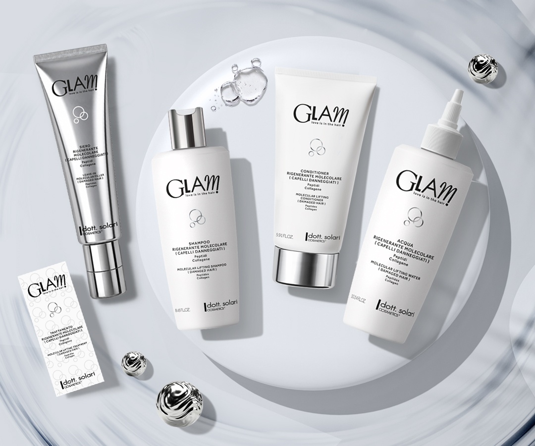 Glam hair care set with silver tubes and bottles of shampoo, conditioner, and molecular water on a white surface